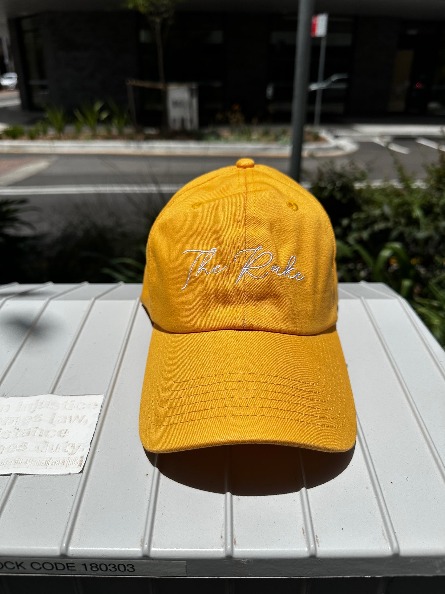 The Rake Logo Dad Cap in Amber Yellow