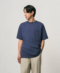 Person wearing a navy blue t-shirt with a red logo on a plain background