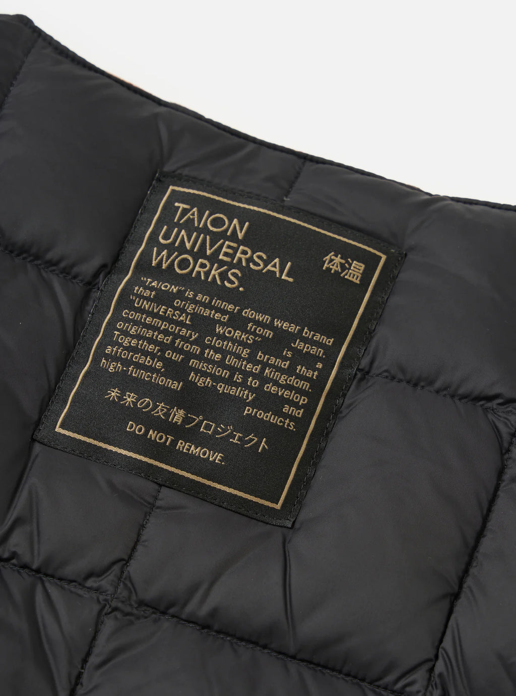 Black puffer jacket with 'TAION UNIVERSAL WORKS' label on a gray background