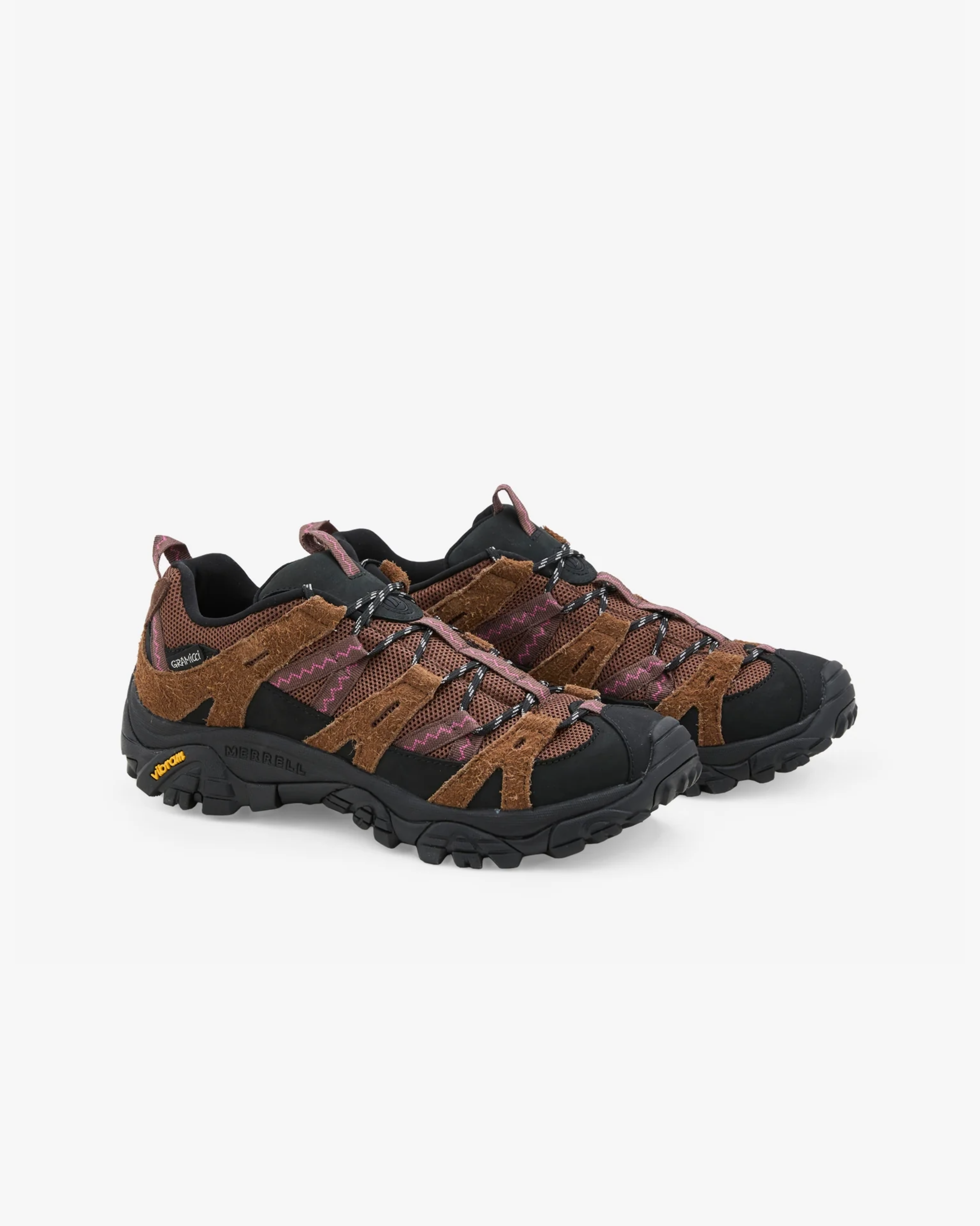 Pair of brown and black hiking shoes on a white background